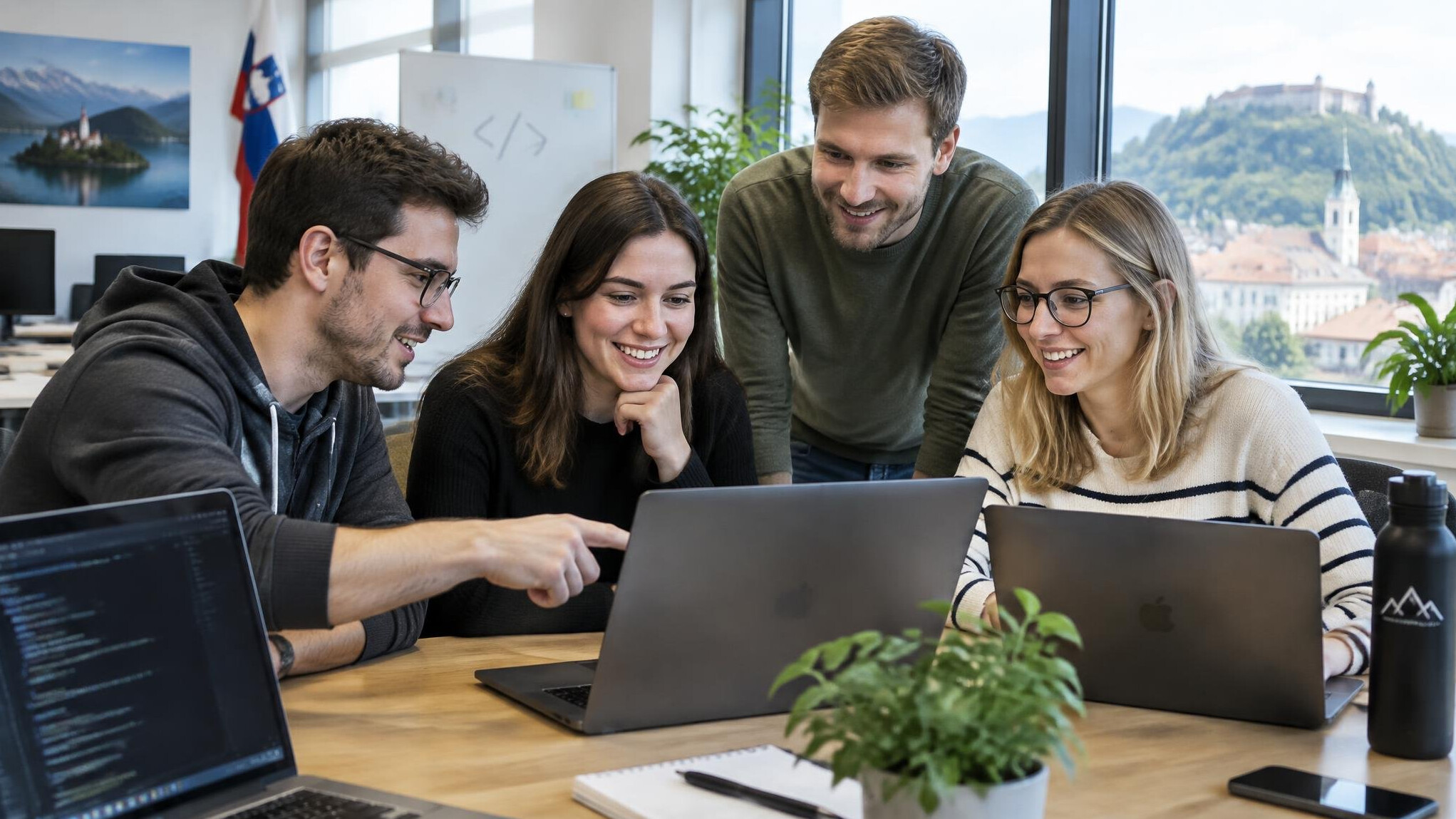 Group of developers collaborating around laptops